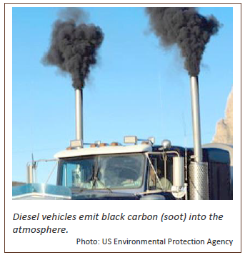 Photograph of a large truck with dual smokestacks belching smoke.