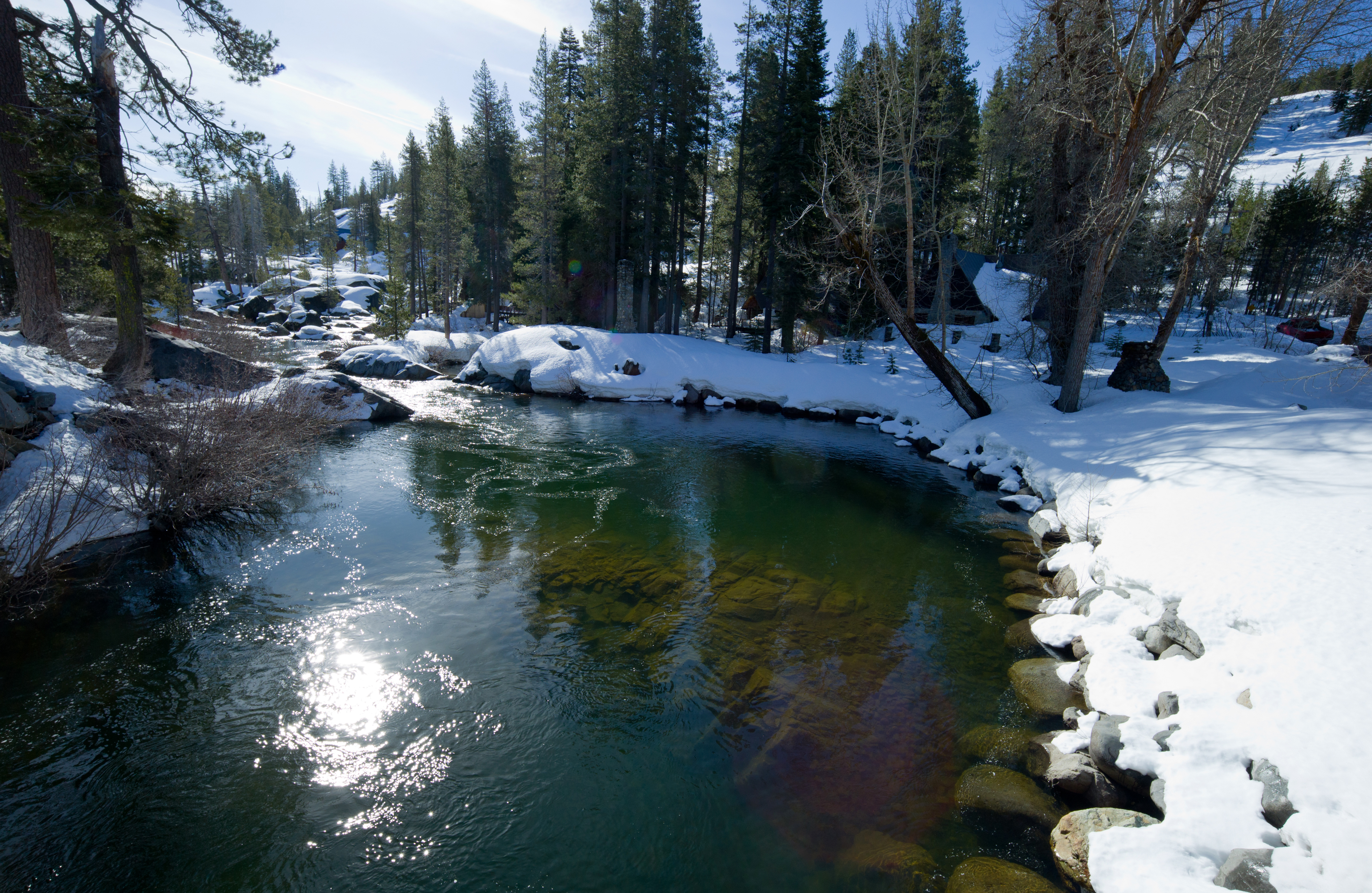 Sierra stream with snow on both banks