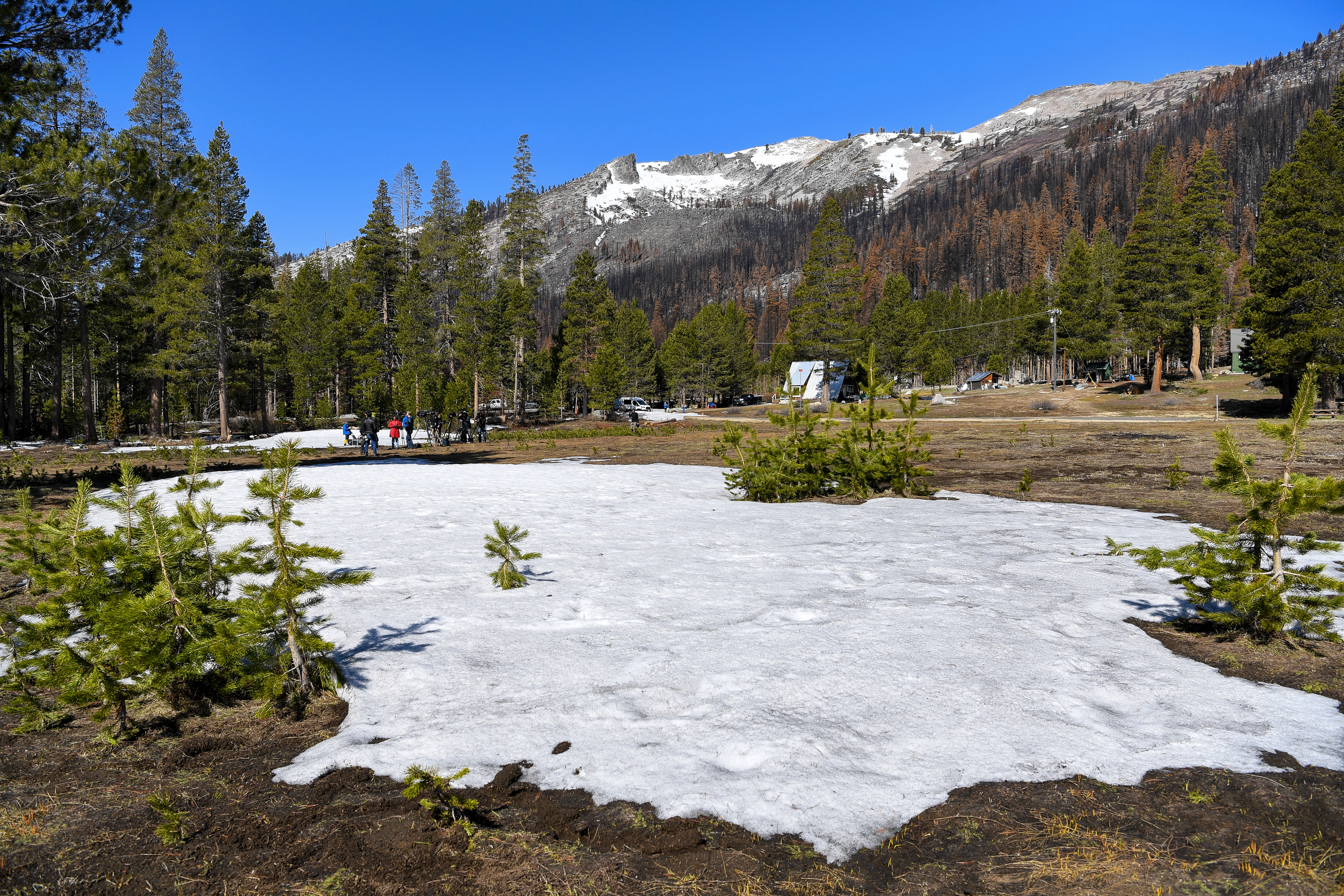 Very little snow remains on the ground for the California Department of Water Resources' fourth snow survey of the 2022 season at Phillips Station in the Sierra Nevada Mountains. The survey is held approximately 90 miles east of Sacramento off Highway 50