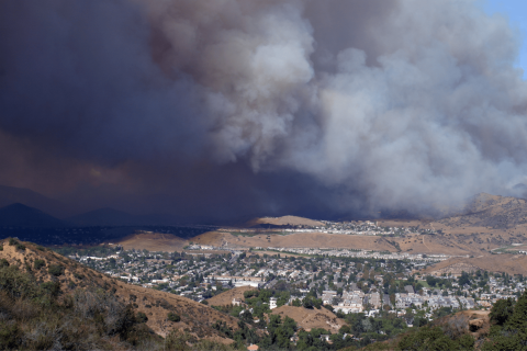 A wildfire above a small town.