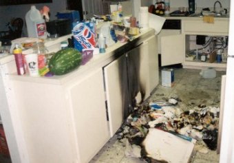 aftermath of a drug lab explosion, kitchen burned and covered with debris