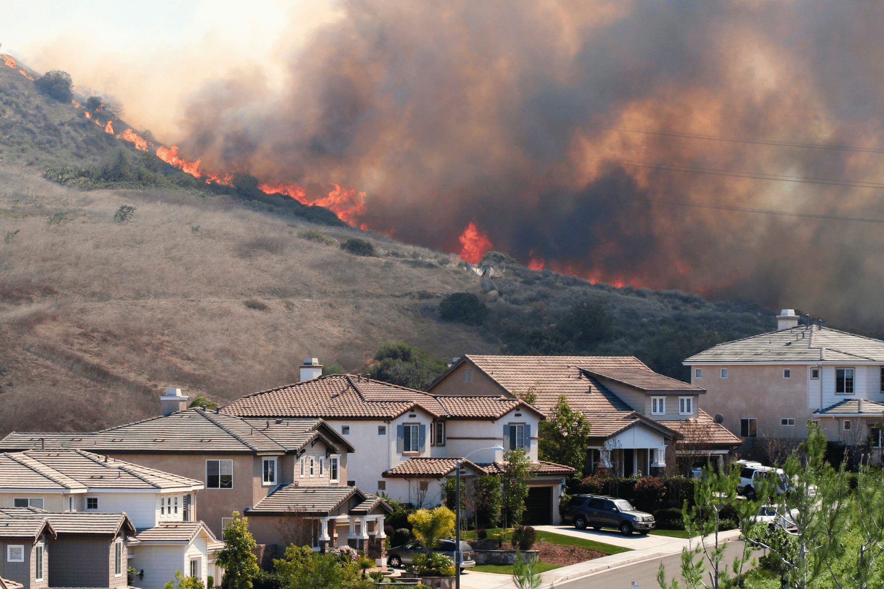 A brush fire near homes in Southern California.